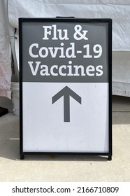 Outdoor Poster For Flu And Covid-19 Vaccines At A Health Clinic