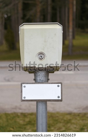 Outdoor power socket for car heating close up with empty white sign.