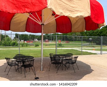 Outdoor Public Pool With Red Umbrella.