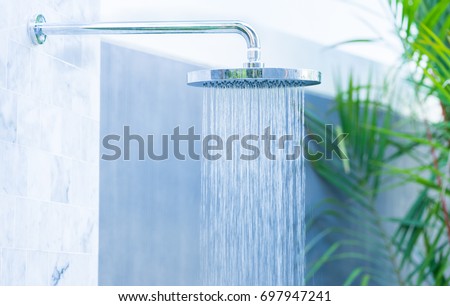 Outdoor rain shower in the beach for swimming pool.Saving water.Summer season.Rain shower.bathroom clean.Hygiene water saving.natural power energy.Sanitize.environment.water day.Ecology.Fresh image.