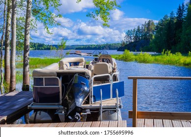Outdoor recreation. Boat for walking on the lake. Motor boat at the pier. Rest in Karelia. Lake Ladoga. A boat with beige leather seats. Motorboat rental. Very beautiful lake in the forest.