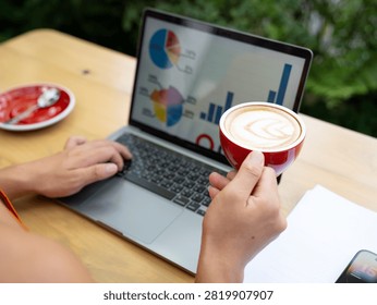 Outdoor Remote Work Setup with Laptop, Coffee, Charts, and Notes
