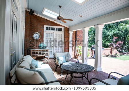 Outdoor Residential Back Patio Porch with Couches and Chairsand a Table