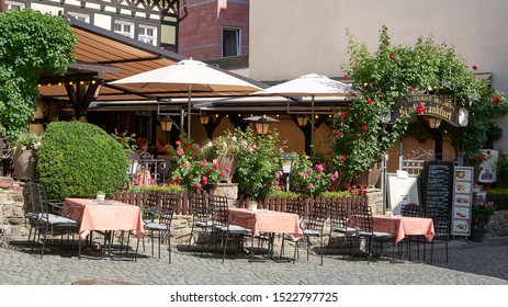 Outdoor Restaurant Patio And Beer Or Wine Garden In The Cobbleston Streets Of The Medieval Tourist Destination Of Rudesheim On The Rhine, Germany. Aug 2019.                              