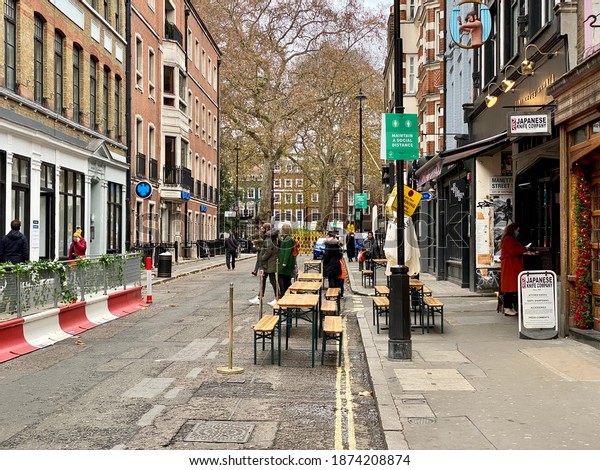 Outdoor restaurant seating during the pandemic in\
Soho London December\
2020