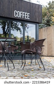 Outdoor Restaurant Terrace. Vintage Cafe With Rattan Chairs And Table. No People. Empty Street Cafe.