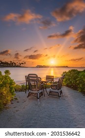 Outdoor restaurant with views of ocean and beautiful sky at sunrise. Group of islands Crossroads Maldives. Long exposure picture. July 2021