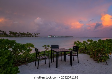 Outdoor restaurant with views of ocean and beautiful sky at sunrise. Maldives. Long exposure picture. July 2021