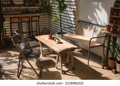 Outdoor Retro Cafe Design With Wooden Table, Chair And Cactus Vase Decorate On Yard