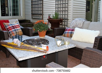 Outdoor Seating Arrangement Around A Gas Fire Pit Table In The Fall