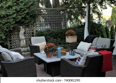 Outdoor Seating Arrangement Around A Gas Fire Pit Table In The Fall