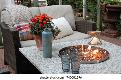 Outdoor Seating Arrangement Around A Gas Fire Pit Table In The Fall