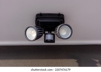 An Outdoor Security Dual Head Flood Light Under The Roof.