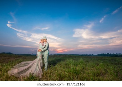 Outdoor shooting for Malay wedding, the bride and groom wearing Malay traditional cloth with  beautiful sunset   as background . - Shutterstock ID 1377121166