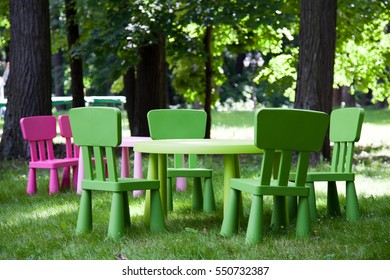 Outdoor Shot Of Children Plastic Chair And Table On Grass At Yard