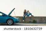 Outdoor shot of couple of travelers sitting near the broken car with open hood, Man and woman looking tired, frustrated while waiting for assistance or tow truck, Web Banner