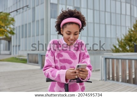 Similar – Image, Stock Photo Girl using electric scooter in the street in downtown rented by using service on smartphone. Candid people, real moments, authentic situations