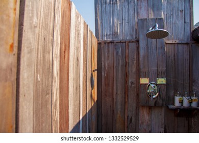 Outdoor Shower With A Large Shower And Shampoo Cream In The Bathroom Made From Wooden Wall For Tourists To Steep A Shower After The Tour.