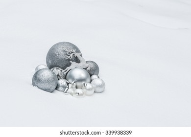 Outdoor silver grey decorative Christmas ornaments with animal Santa Claus's reindeer at natural snow background
