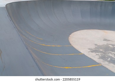 Outdoor Skatepark With Blue Sky And Grey Concrete