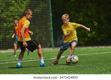 Outdoor Soccer Game. Teen boys in motion during soccer game, playing, raining on green field. Growing skills and endurance. Concept of sport, school, childhood, hobby, active lifestyle - Powered by Shutterstock