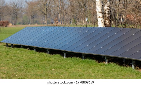 Outdoor Solar Cell Panel In Countryside, Photovoltaic Cell Is An Electrical Device That Converts The Energy Of Light Directly Into Electricity By The Photovoltaic Effect, Green Energy Background.