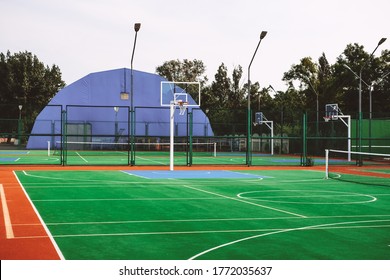 Outdoor sports field with artificial turf
for playing tennis and basketball.