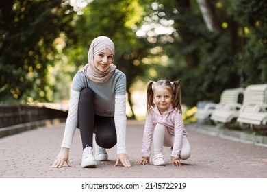 Outdoor Sports And Fitness Family. Running And Jogging. Sporty Arabian Mother And Her Cute Daughter On Running Track Getting Ready To Start Run. Woman And Child In A Park.