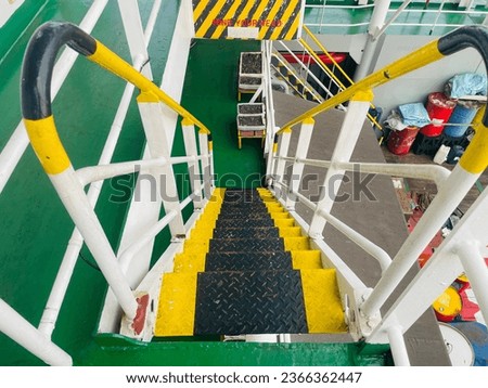 Outdoor stairs on the ship as access for crew and passengers to walk. Steel ladder on the ship leading down.