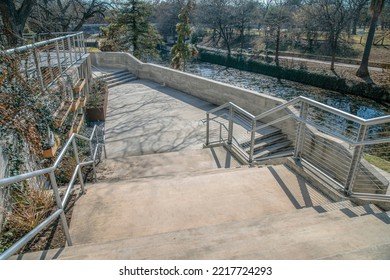 Outdoor Stairs With View Of The Canal And Park At San Antonio River Walk Texas. Sunny Day Landscape With Concrete Staircase Along The River At A Popular Tourist Destination.