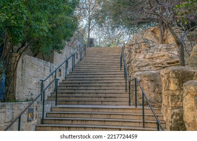 Outdoor Stairway By The San Antonio River Walk In Texas On A Beautiful Day. The Concrete Steps With Railings Is Flanked By Stone Half Walls And Small Trees.