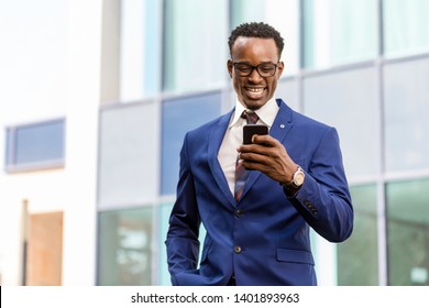 Outdoor Standing Portrait Of A Black African American Business Man Using A Mobile  Phone