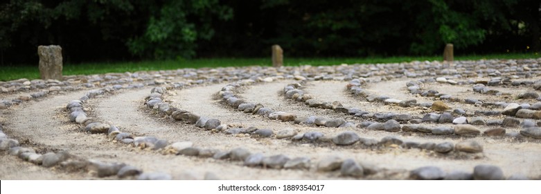 Outdoor stone labyrinth for meditation - Shutterstock ID 1889354017