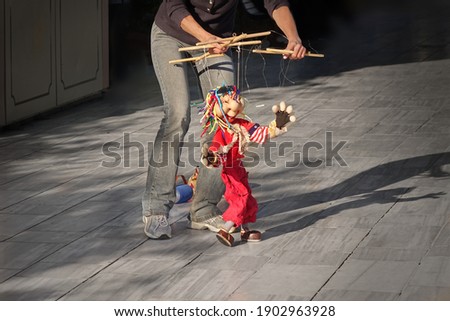 Outdoor Street Performance With  Puppet. Women Dance With Her Puppet.
