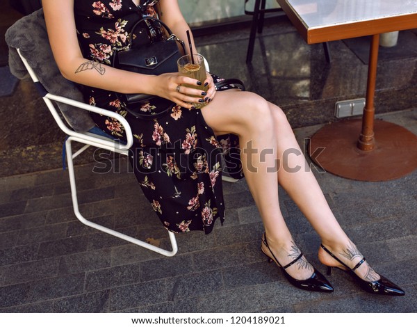 Outdoor\
street style fashion details, young woman posing on the street,\
wearing maxi vintage dress and kitten heels, glamour and elegant ,\
holding tasty lemonade, trendy stylish\
woman.