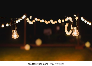 Outdoor String Lights Hanging On A Line In Backyard