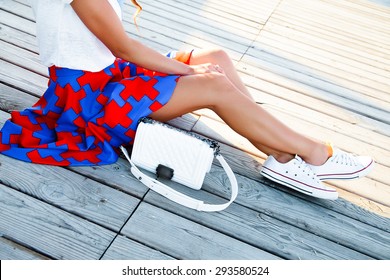 Outdoor summer lifestyle fashion portrait of young hipster stylish woman walking,sitting on the wooden floor,wearing vintage clothes,stylish clothes,clear fresh colors.bright colors,trendy outfit,bag - Powered by Shutterstock