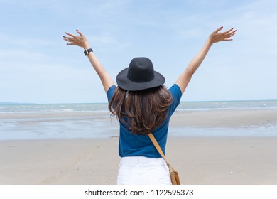 Outdoor Summer Portrait Women Put Her Hands Up To Say Hi The Ocean,wearing A Black Hat And Receive A Fresh Air From The Sea 