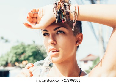 Outdoor Summer Portrait Of Young Woman Drinking Water.  Dark-haired Girl At Hot Summer Day