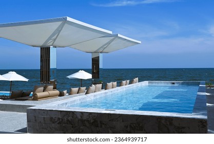 Outdoor swimming pool next to the sea - Shutterstock ID 2364939717