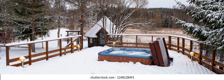 Outdoor swimming pool-Jacuzzi with fresh blue water in winter in Finland. Sauna and Finnish traditions. - Shutterstock ID 1248128491