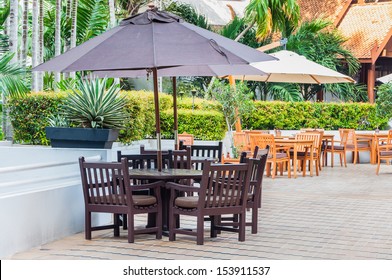 Outdoor Table Set With Umbrella In The Terrace