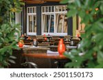 Outdoor tables at Alsatian winstub restaurants in a city square surrounded by traditional half timbered houses in Strasbourg, Alsace, France