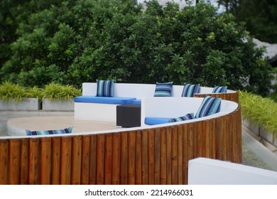 Outdoor tables and sofas on roof terrace background.