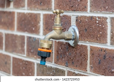Outdoor Tap Faucet In Brick Wall