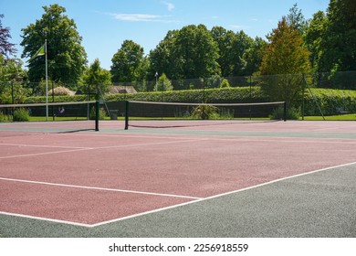 outdoor tennis courts in public park. rubber surface tennis courts with nets for recreational use  - Shutterstock ID 2256918559
