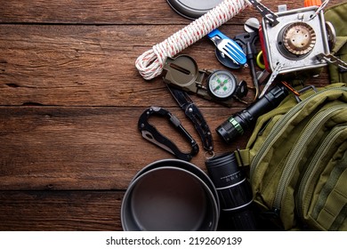 Outdoor Travel Equipment Planning. Camping Trip On Wooden Table Background.