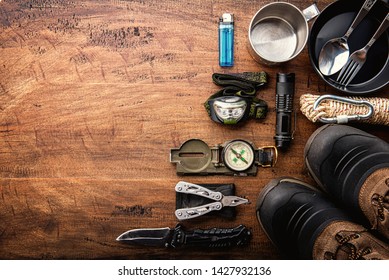 Outdoor Travel Equipment Planning For A Mountain Trekking Camping Trip On Wooden Background. Top View - Vintage Film Grain Filter Effect Styles