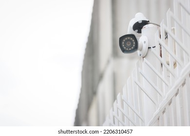 Outdoor Type CCTV Installing On The Fence Pole Top Of The Wall For Security Monitoring And Protection Against Crime. Surveillance Camera System And Safety Technology Concept.