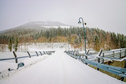 Outdoor View Of Metalllic Structure Protection Close To Water Reservoir, With Light Lamps Located At One Side Of The Road In Hardangervidda In Norway
